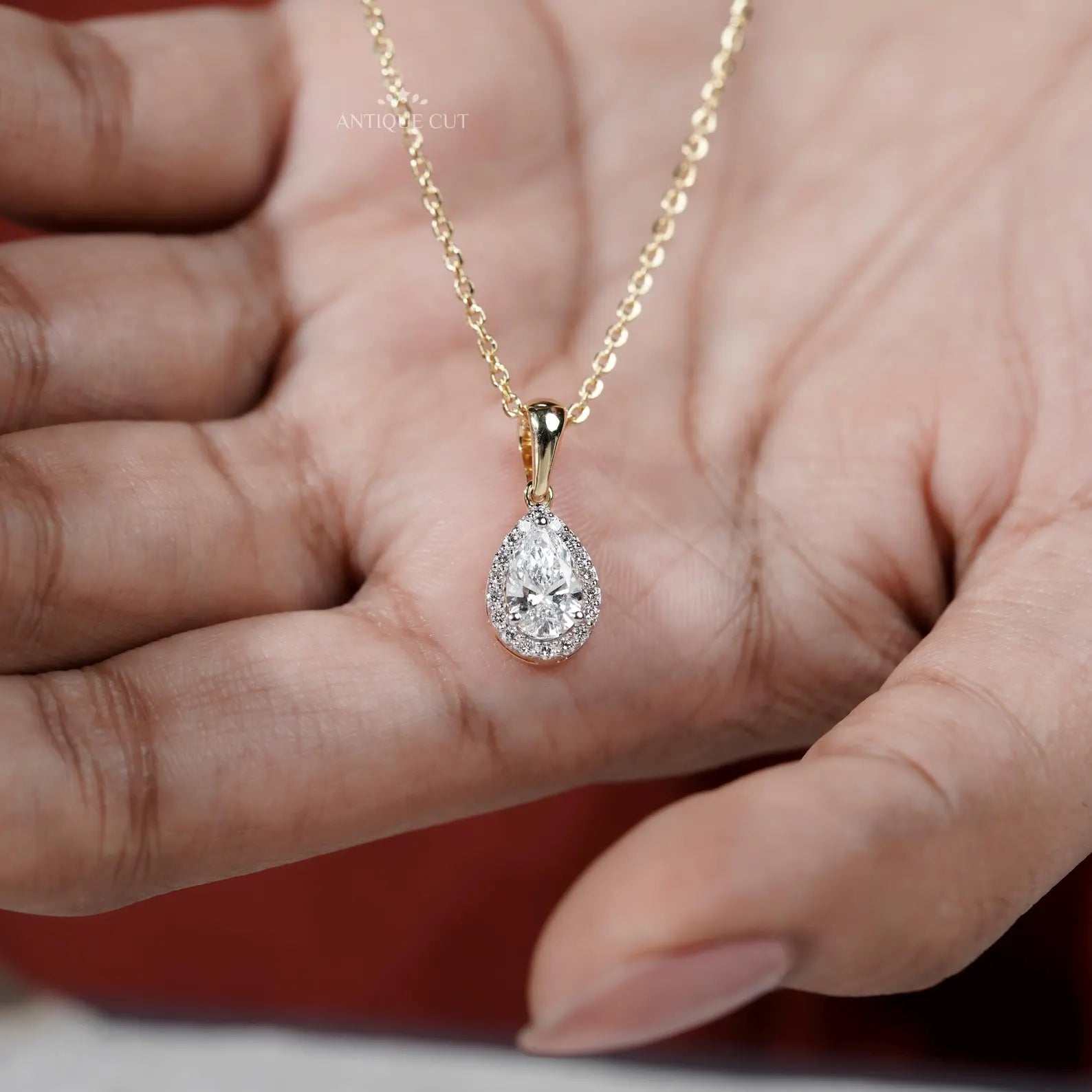 Classic pear cut pendant with halo diamonds
