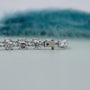 Diamond bracelet with various cut stones on a light gray background