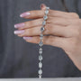 Close-up of hands holding a diamond bracelet