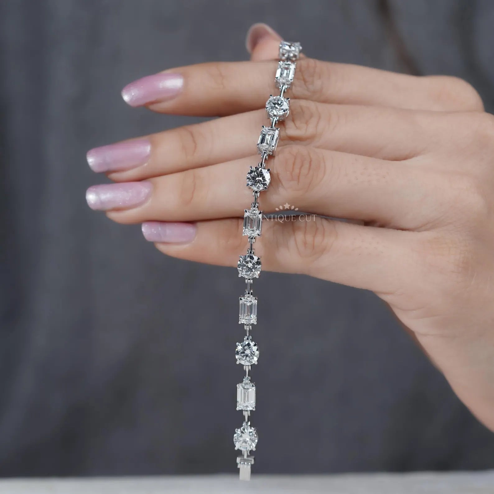 Close-up of hands holding a diamond bracelet