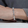 Close-up of hands holding a diamond bracelet