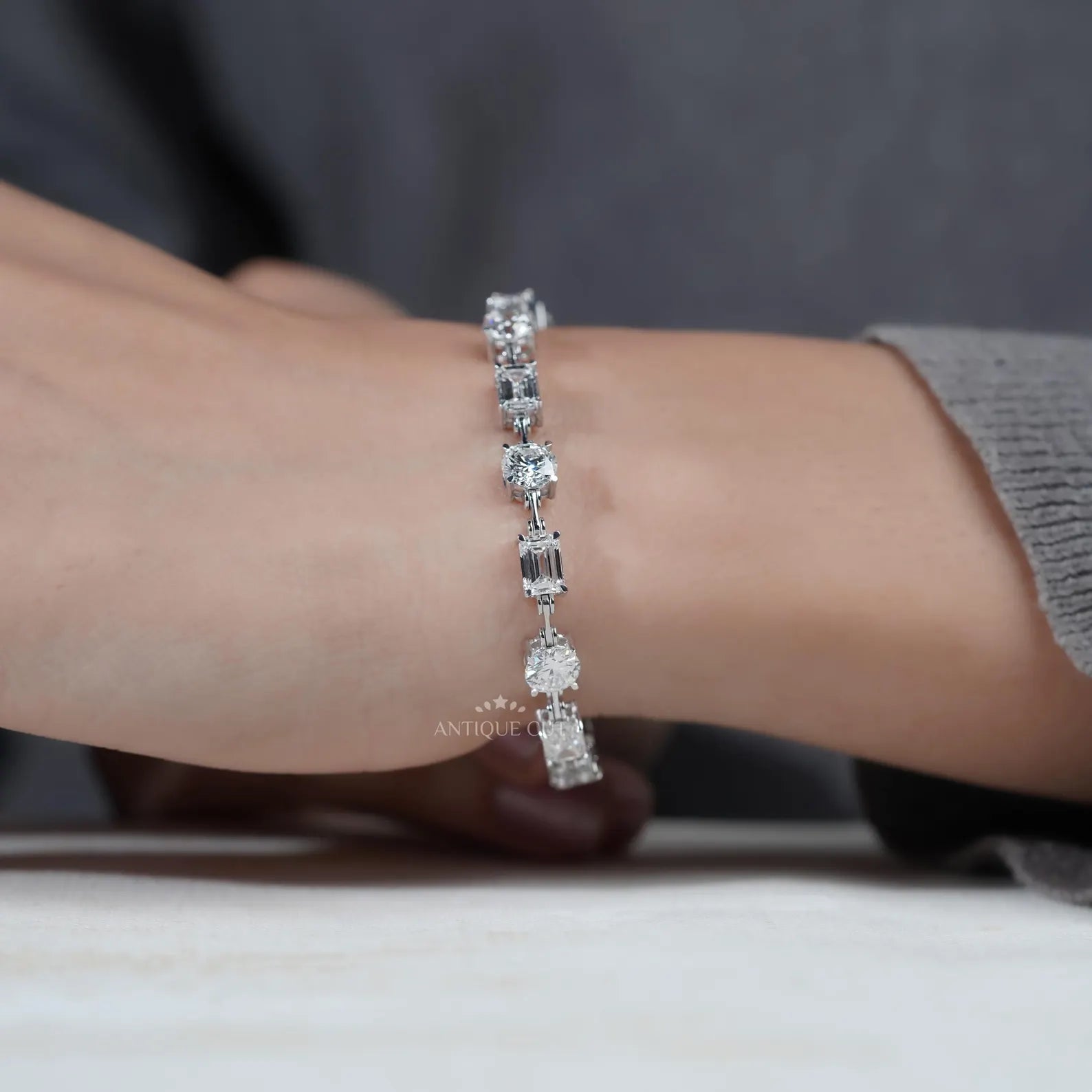 Close-up of hands holding a diamond bracelet