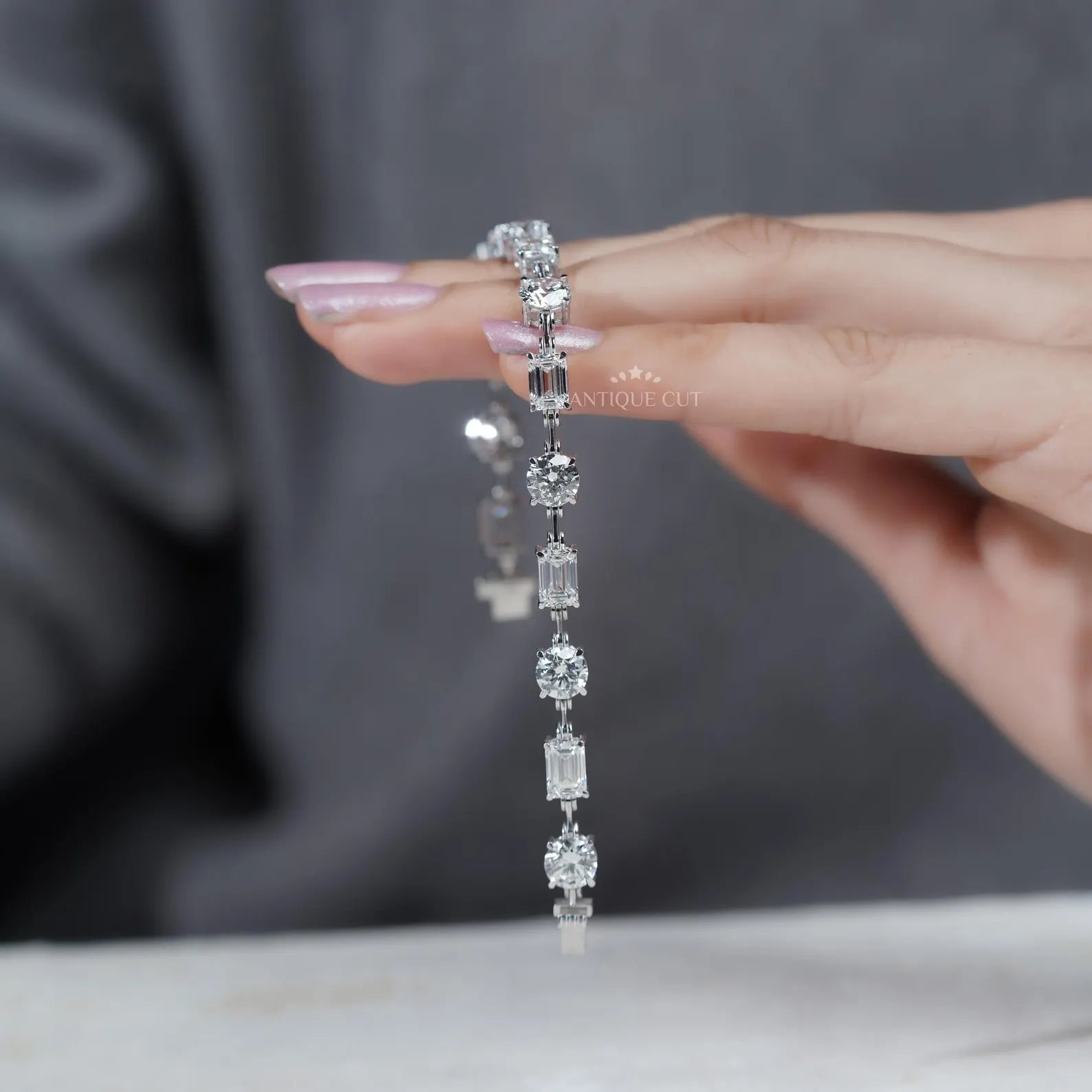 Close-up of hands holding a diamond bracelet