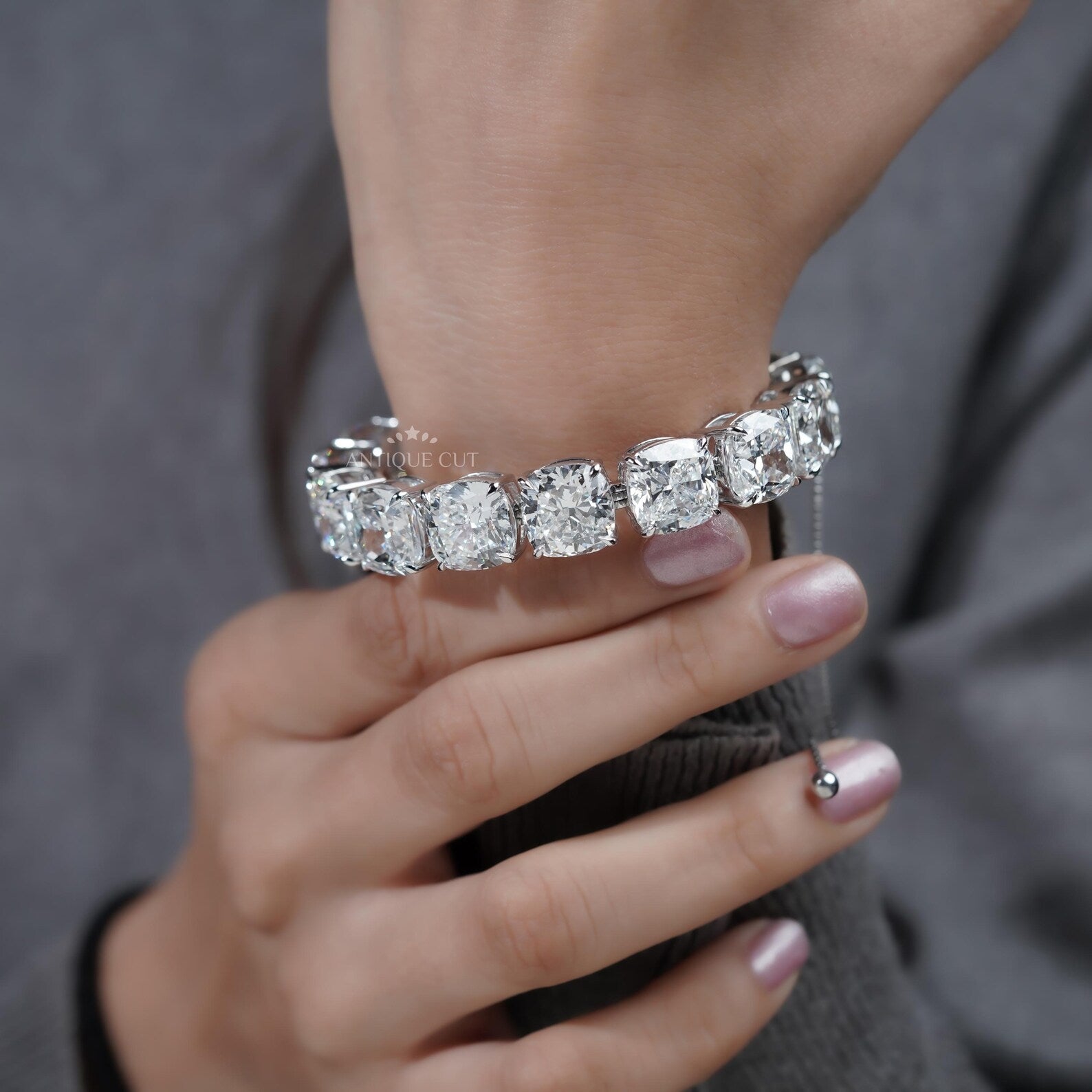 Silver bracelet with large gemstones on a light blue background