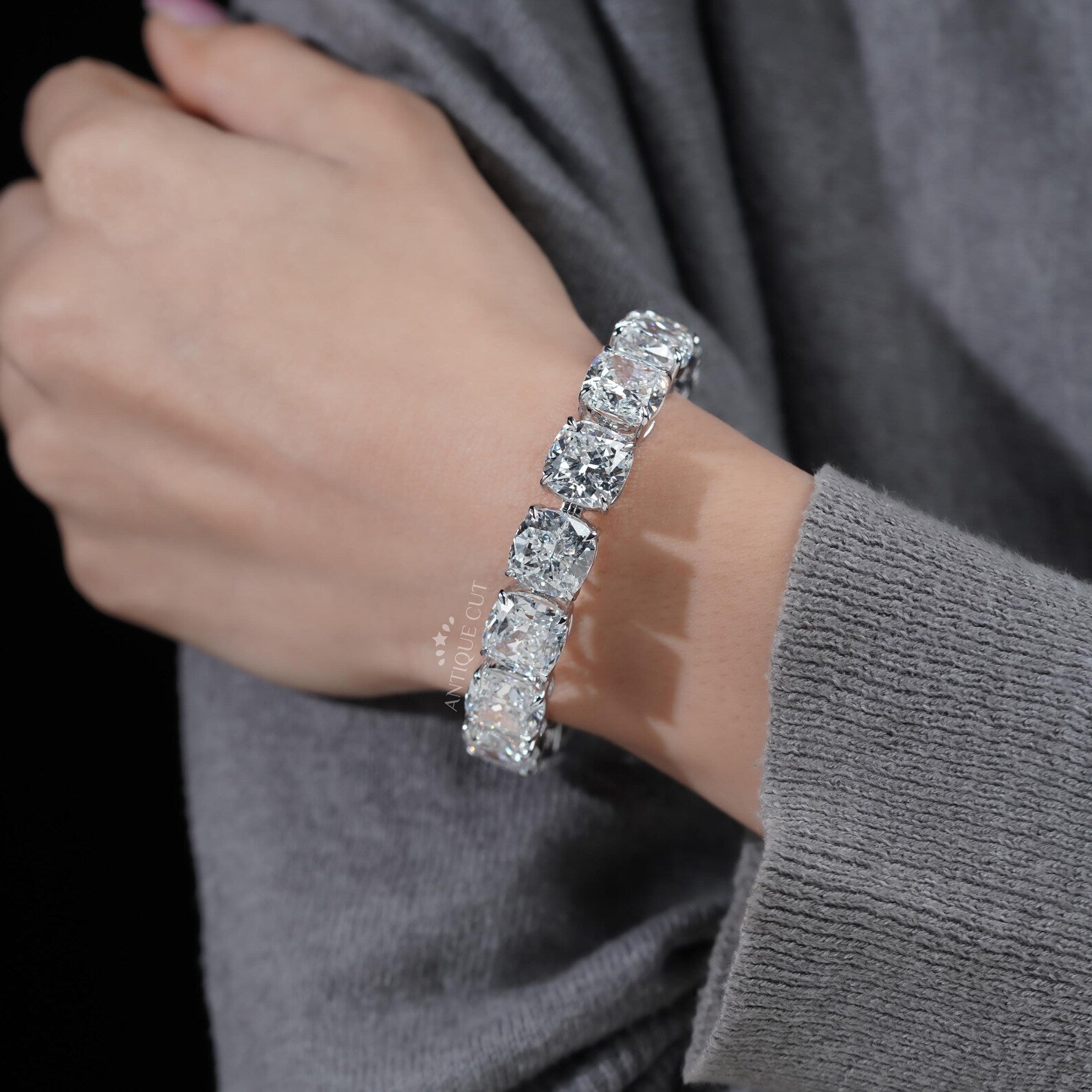 Silver bracelet with large gemstones on a light blue background