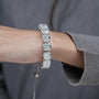 Silver bracelet with large gemstones on a light blue background