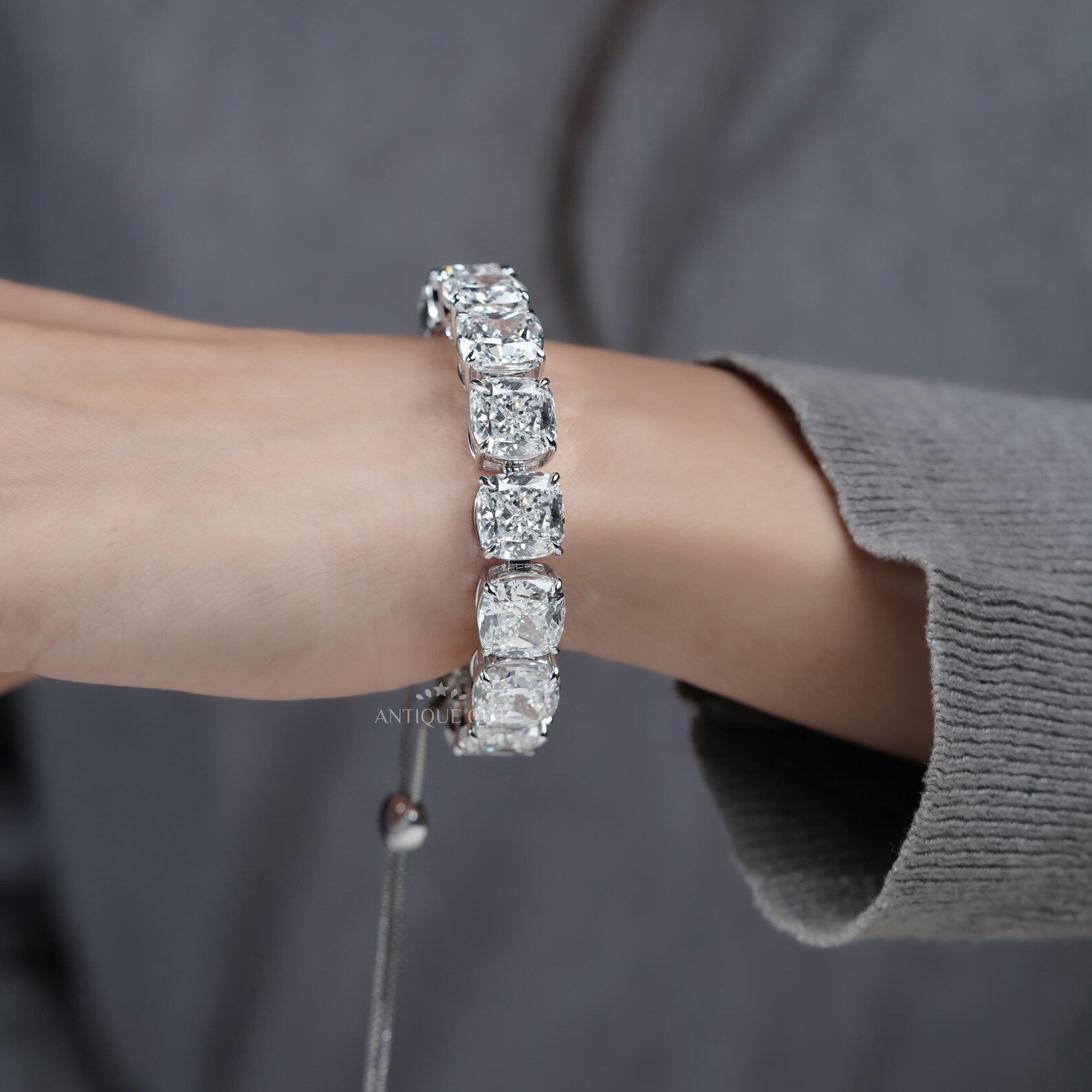 Silver bracelet with large gemstones on a light blue background