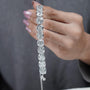 Silver bracelet with large gemstones on a light blue background