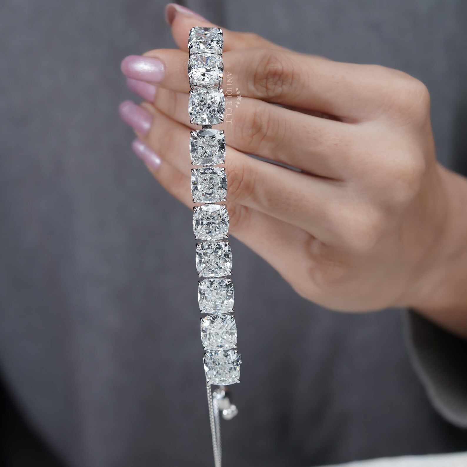 Silver bracelet with large gemstones on a light blue background