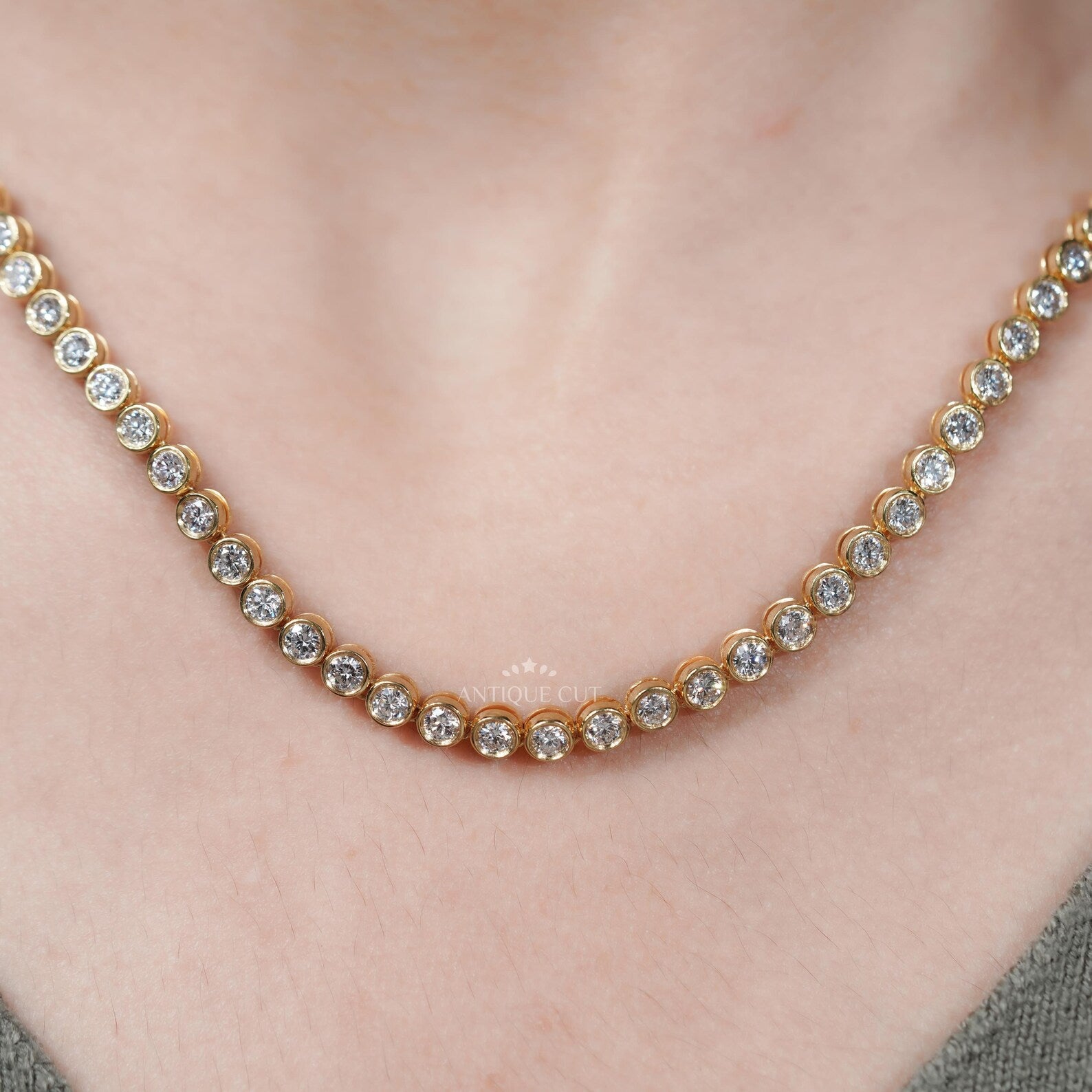 Gold necklace with diamonds on a person's neck
