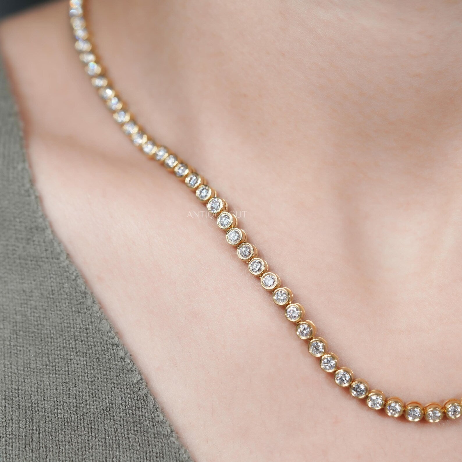 Gold necklace with diamonds on a person's neck