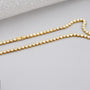 Gold necklace with diamonds on a person's neck