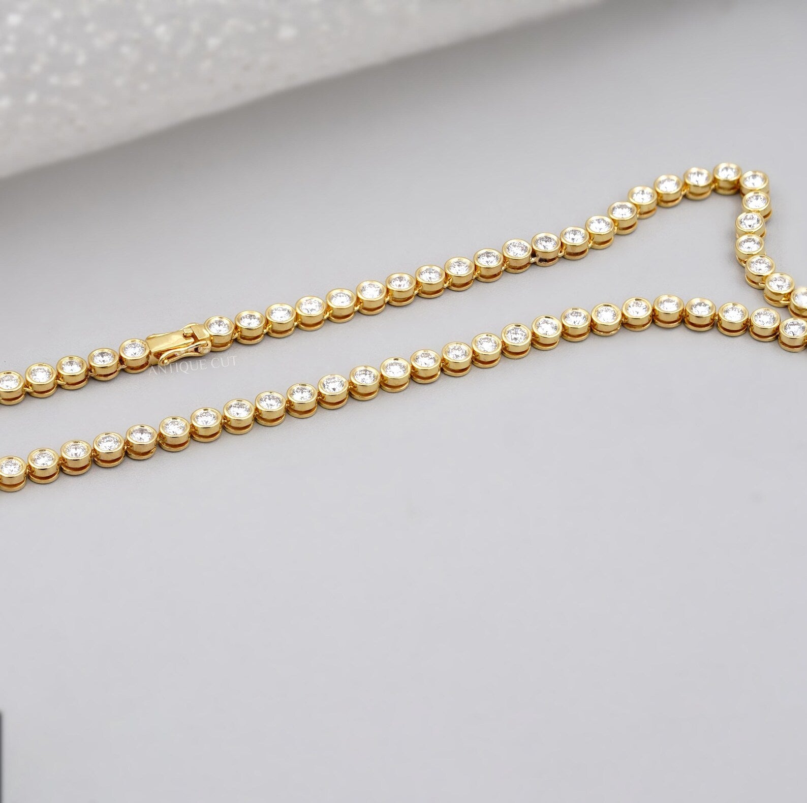 Gold necklace with diamonds on a person's neck