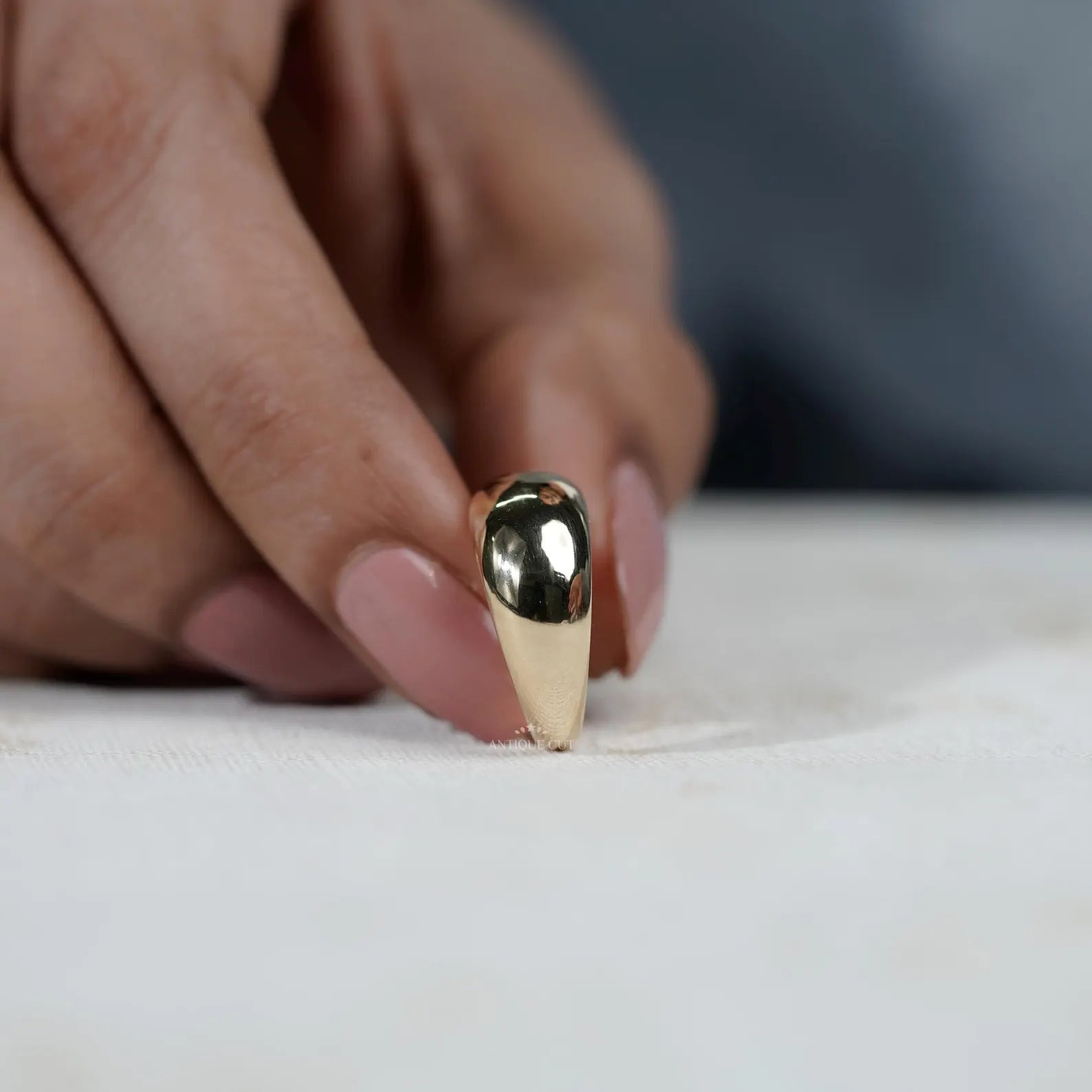 Gold ring on a light gray background

