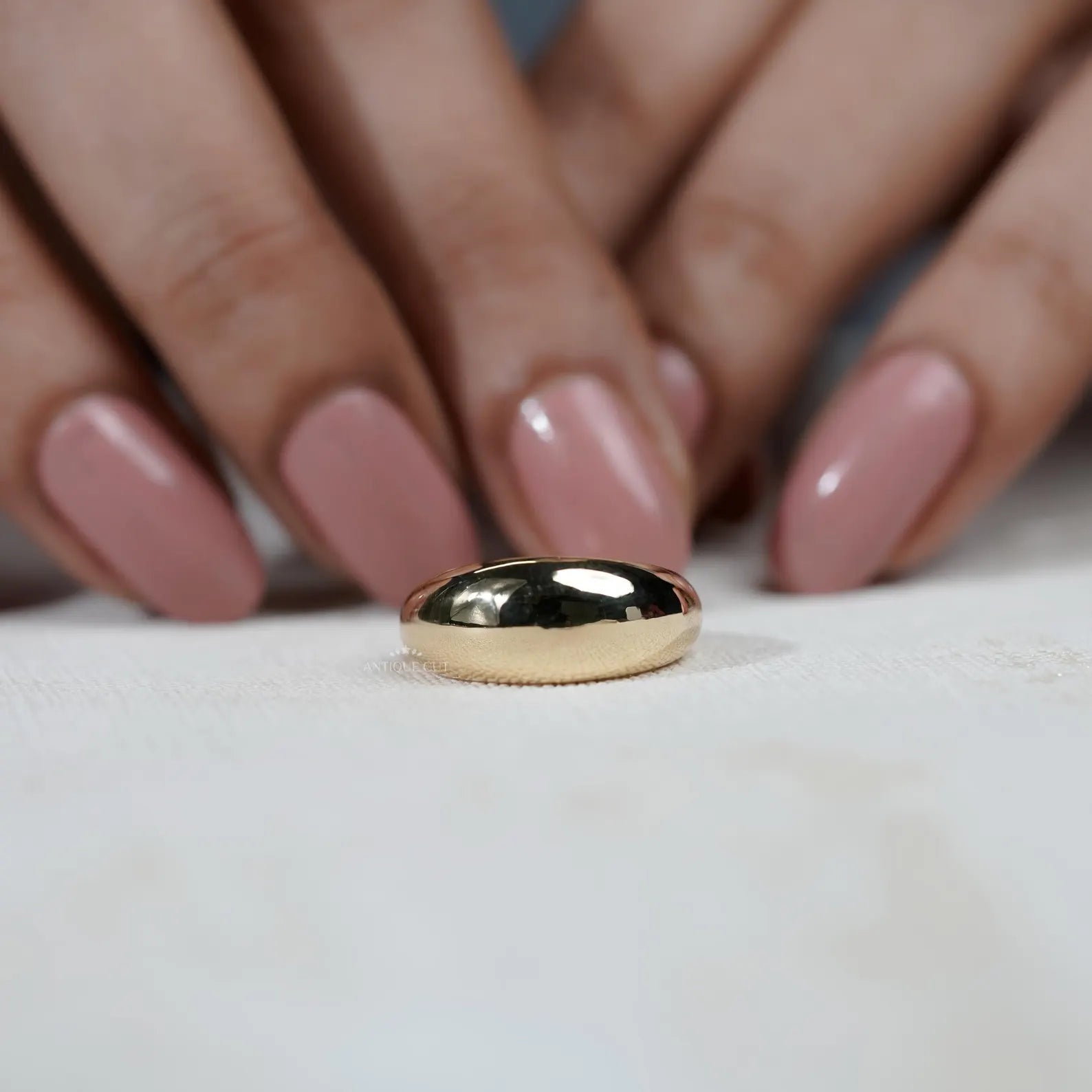 Gold ring on a light gray background

