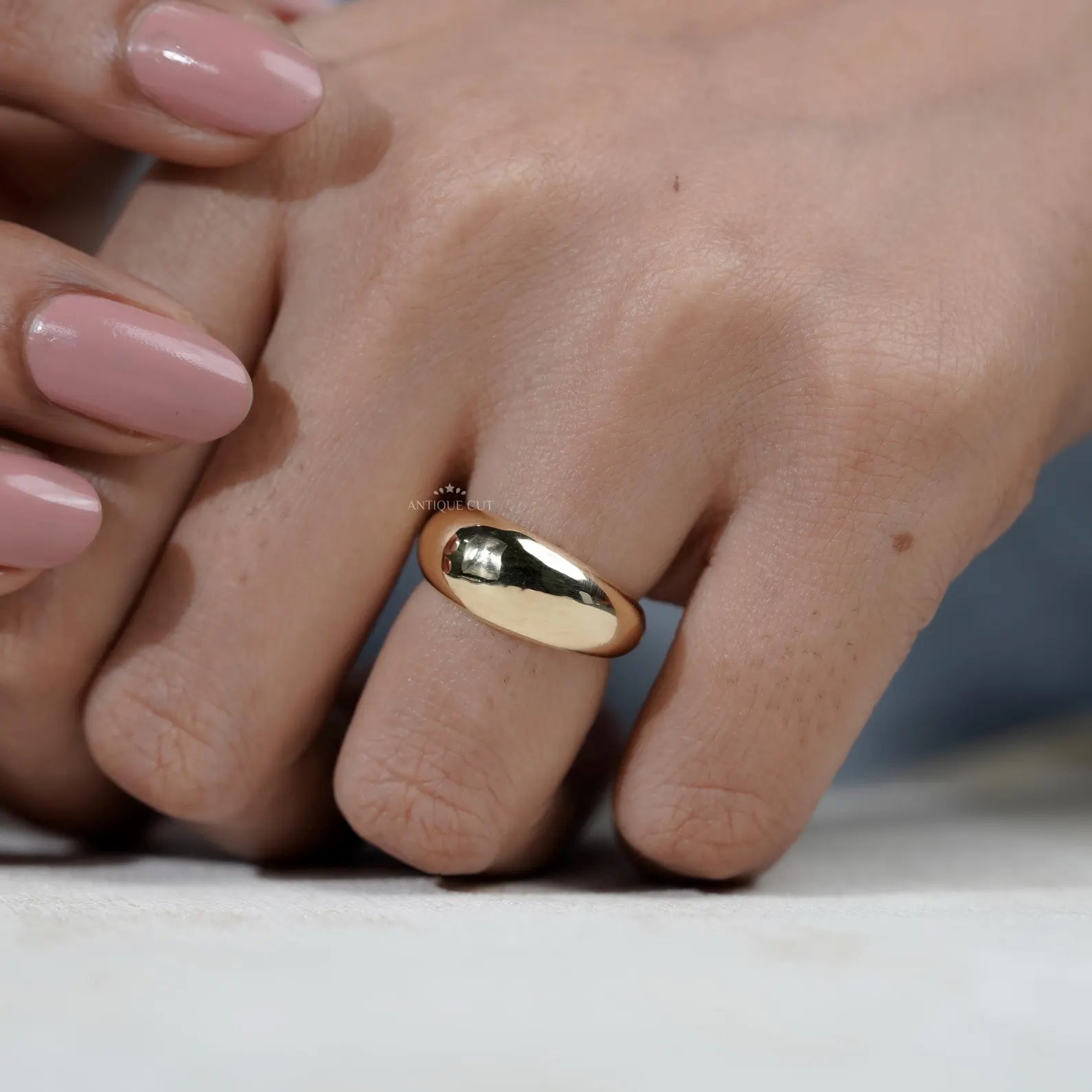 Gold ring on a light gray background

