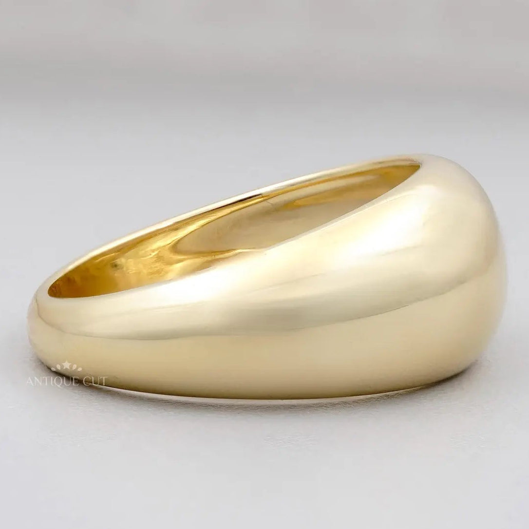 Gold ring on a light gray background

