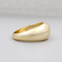 Gold ring on a light gray background

