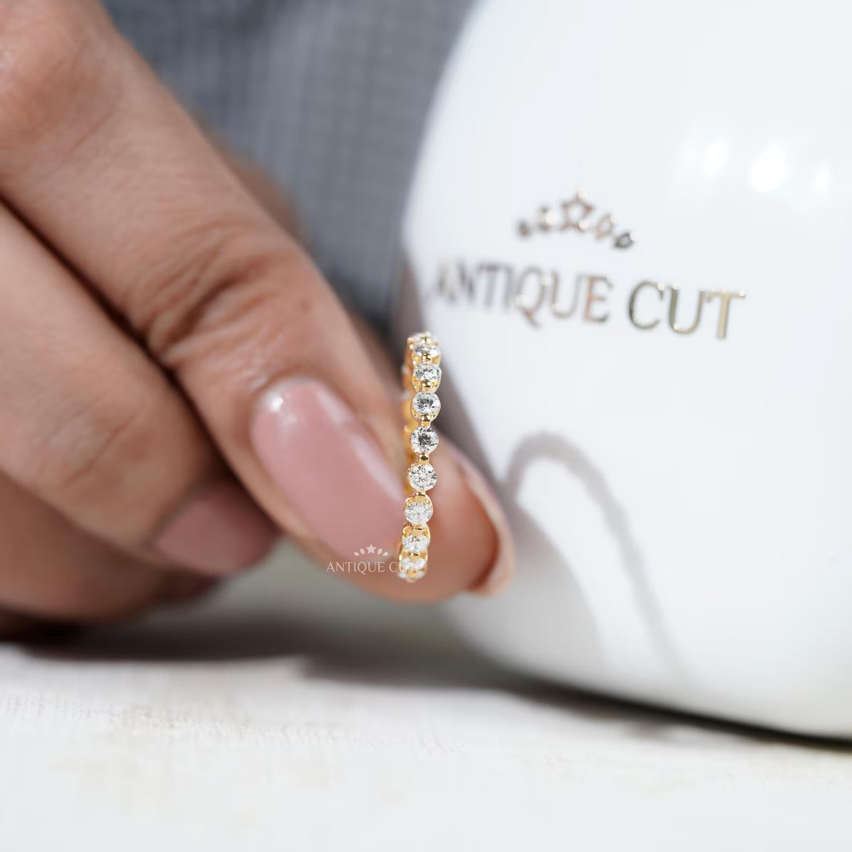 Round diamond wedding band with shared prong setting