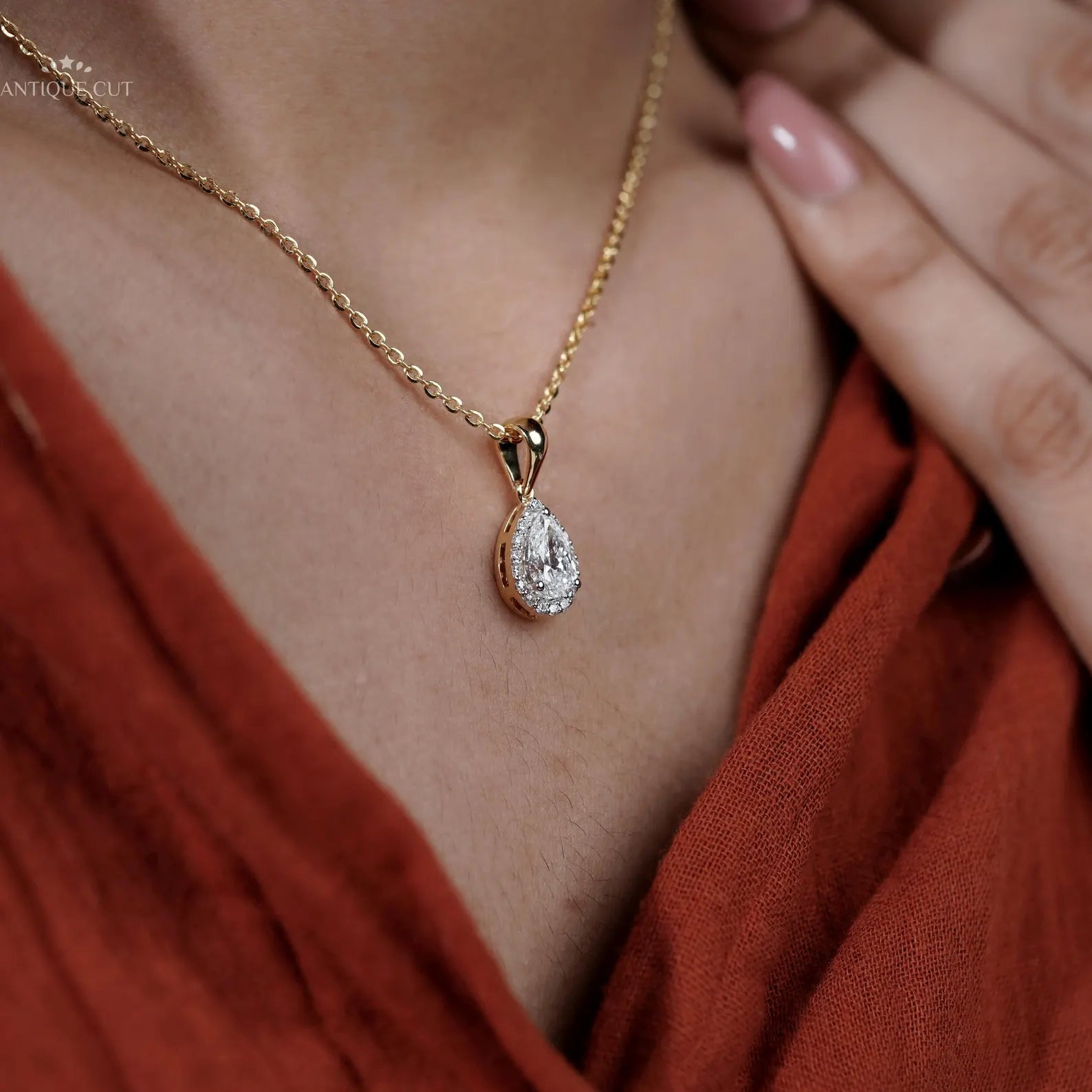 Yellow gold pear cut pendant with round halo diamonds