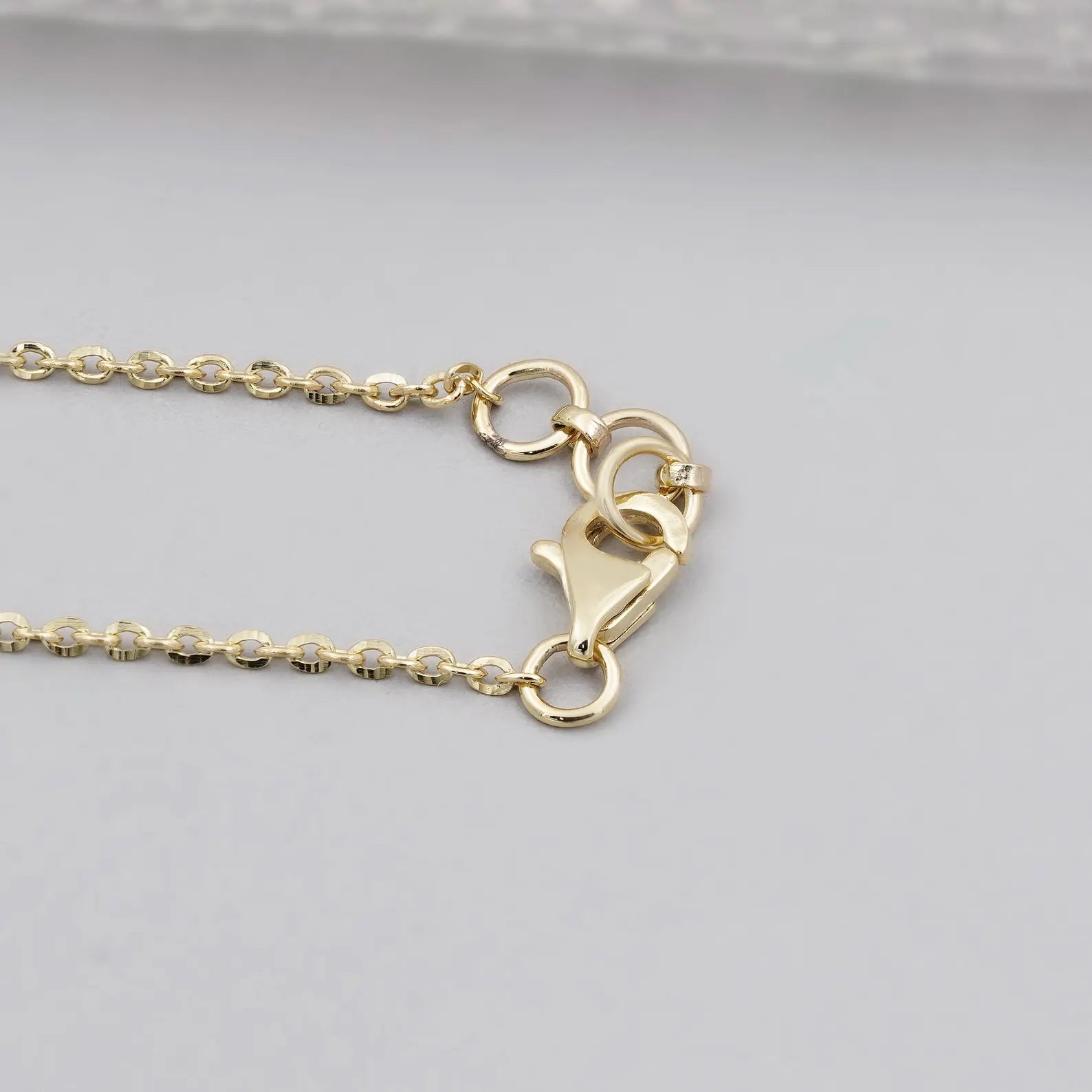 yellow gold pendant bail and lobster clasp attached to a delicate chain.