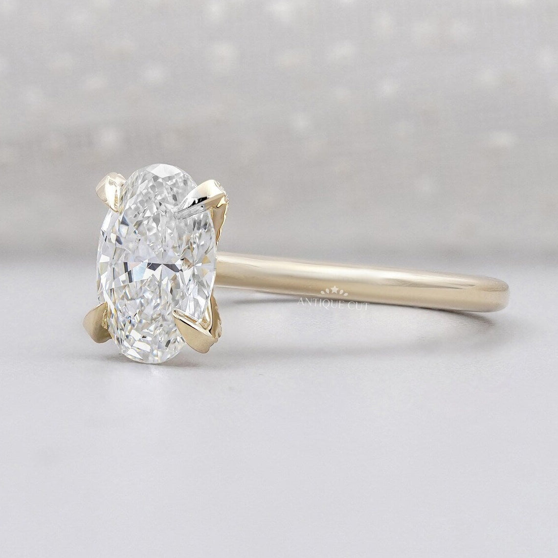 Oval solitaire diamond ring with hidden halo