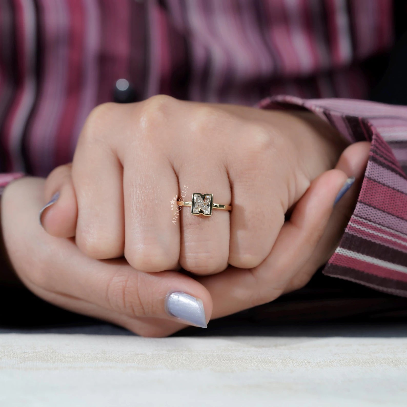 Yellow gold N letter ring with bezel set lab grown diamonds