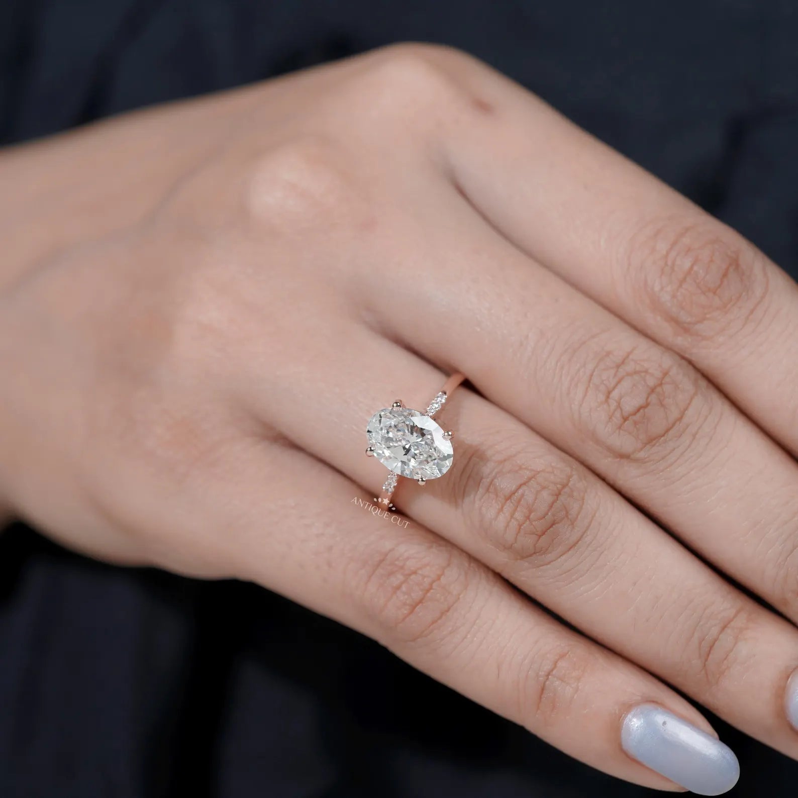 Oval center diamond ring with pavé rose gold band