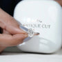 Oval diamond ring with cathedral shoulders and pavé setting