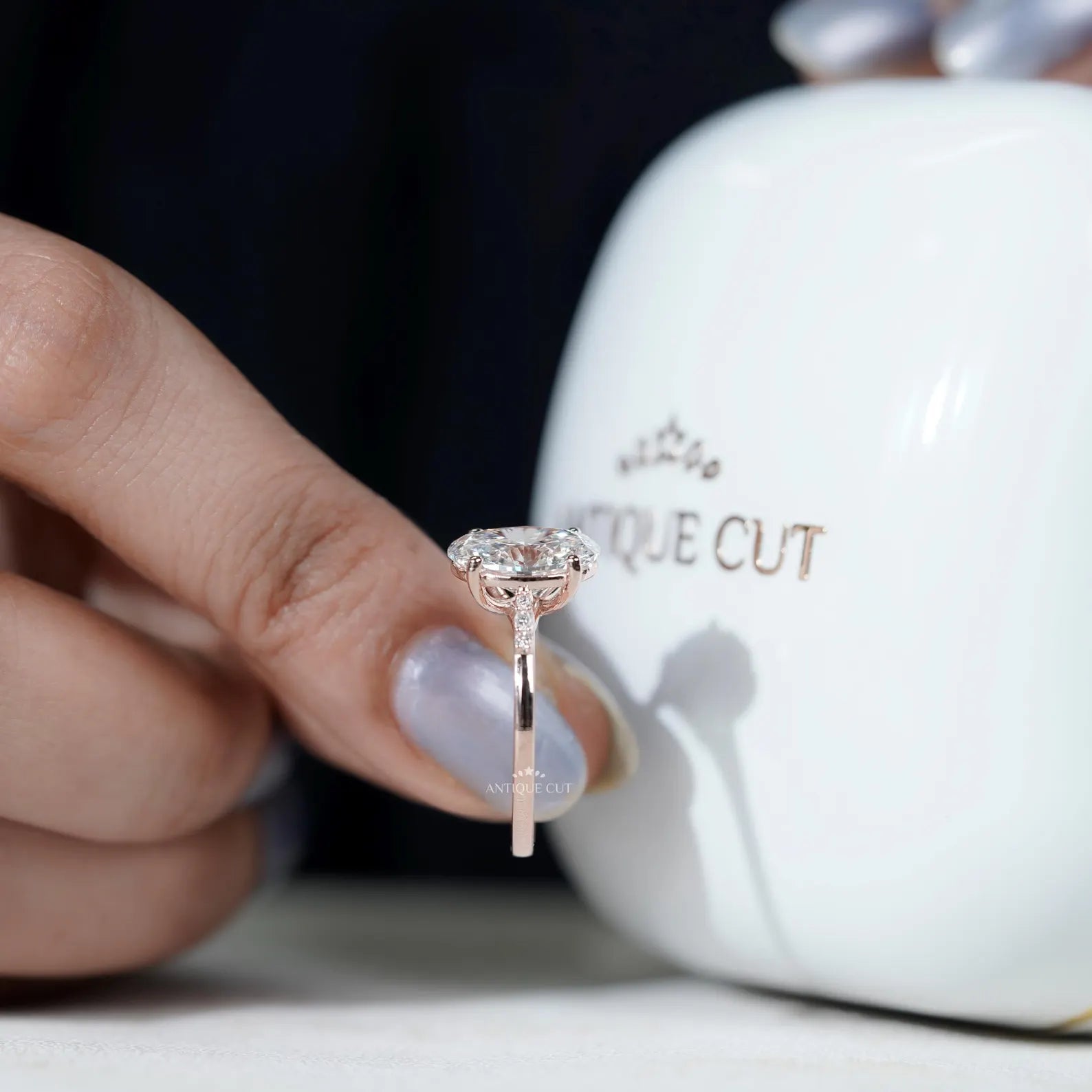 Rose gold oval engagement ring with diamond pavé band