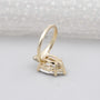 Pear shaped diamond engagement ring with side stones and claw prong setting