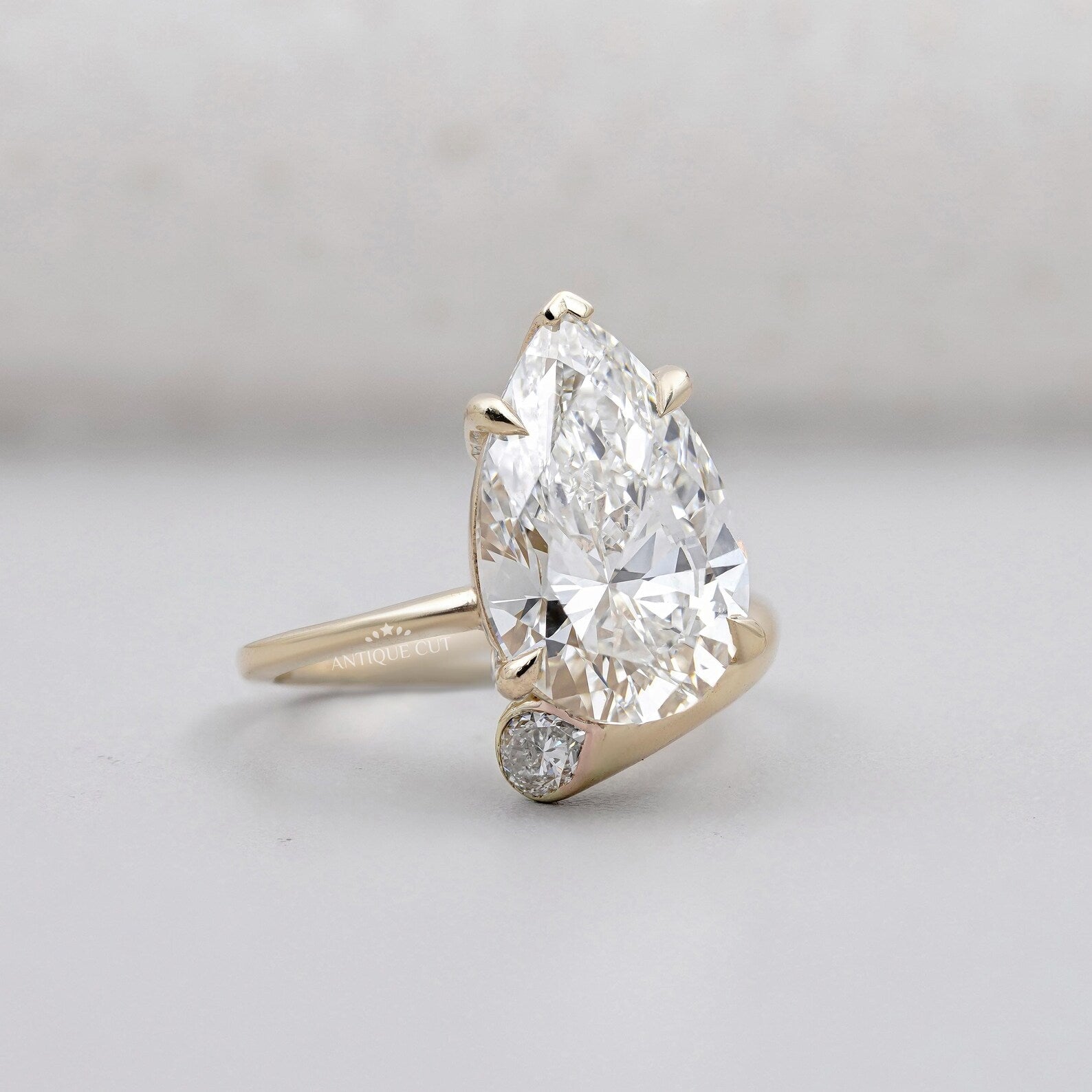 Solitaire Pear Shape Diamond Ring With Side Stone Pear In Yellow Gold