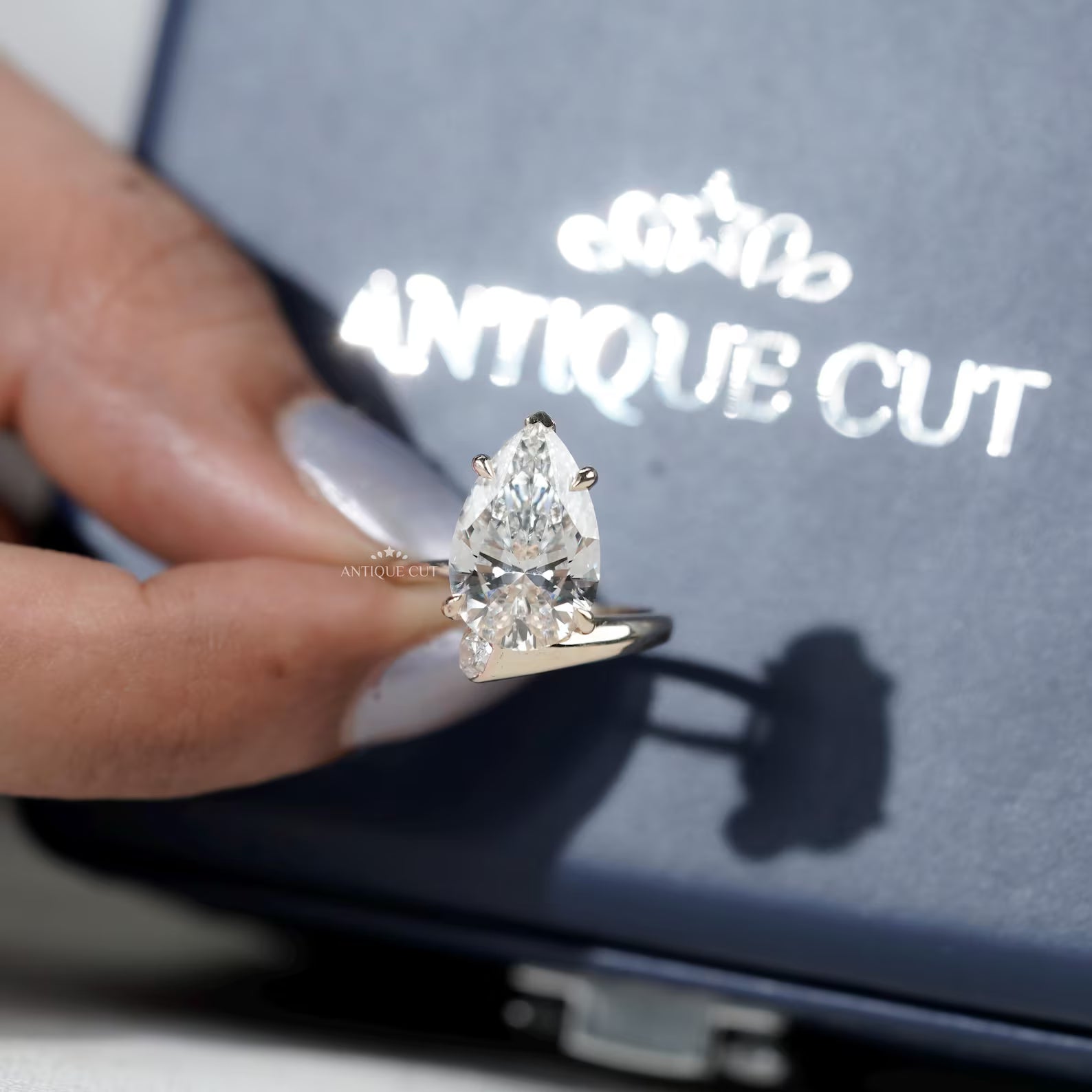 Yellow gold pear diamond ring with claw prongs and lab grown side diamonds
