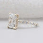 Lab grown radiant diamond ring with pavé band and yellow gold claw prong setting