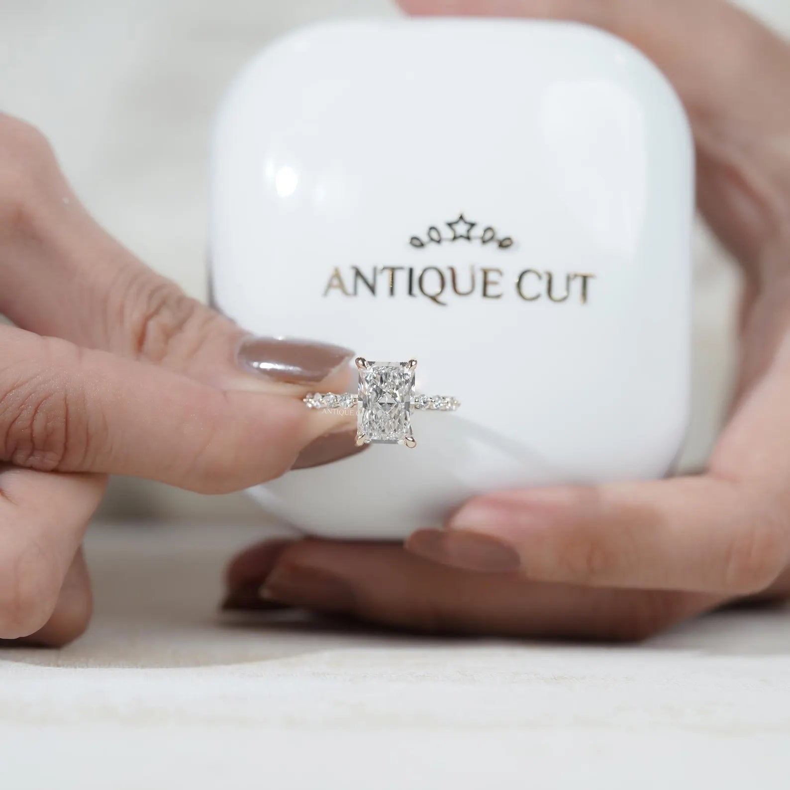 Antiquecut radiant cut engagement ring with hidden halo and pavé diamond setting