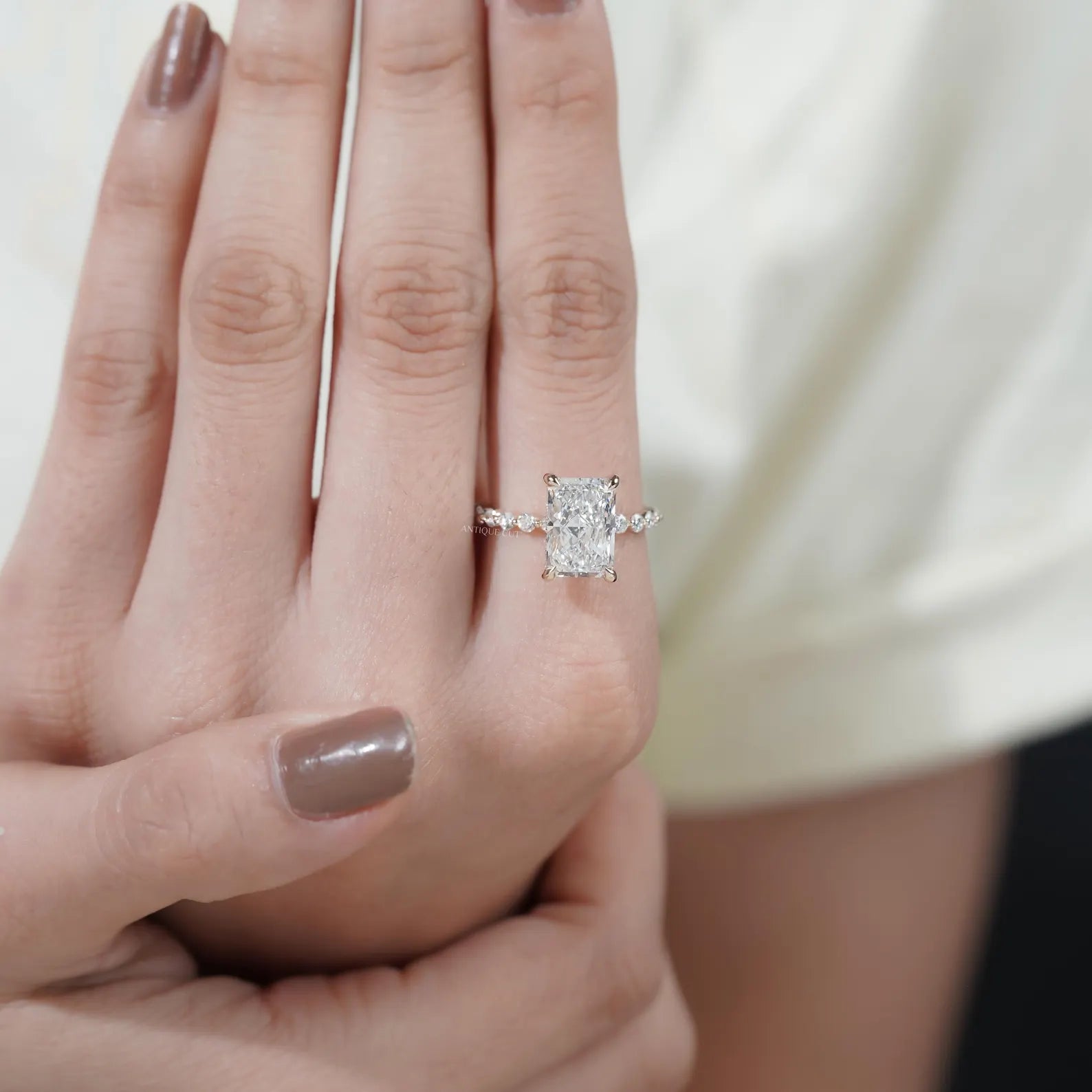 Antiquecut radiant cut engagement ring with hidden halo and pavé diamond setting