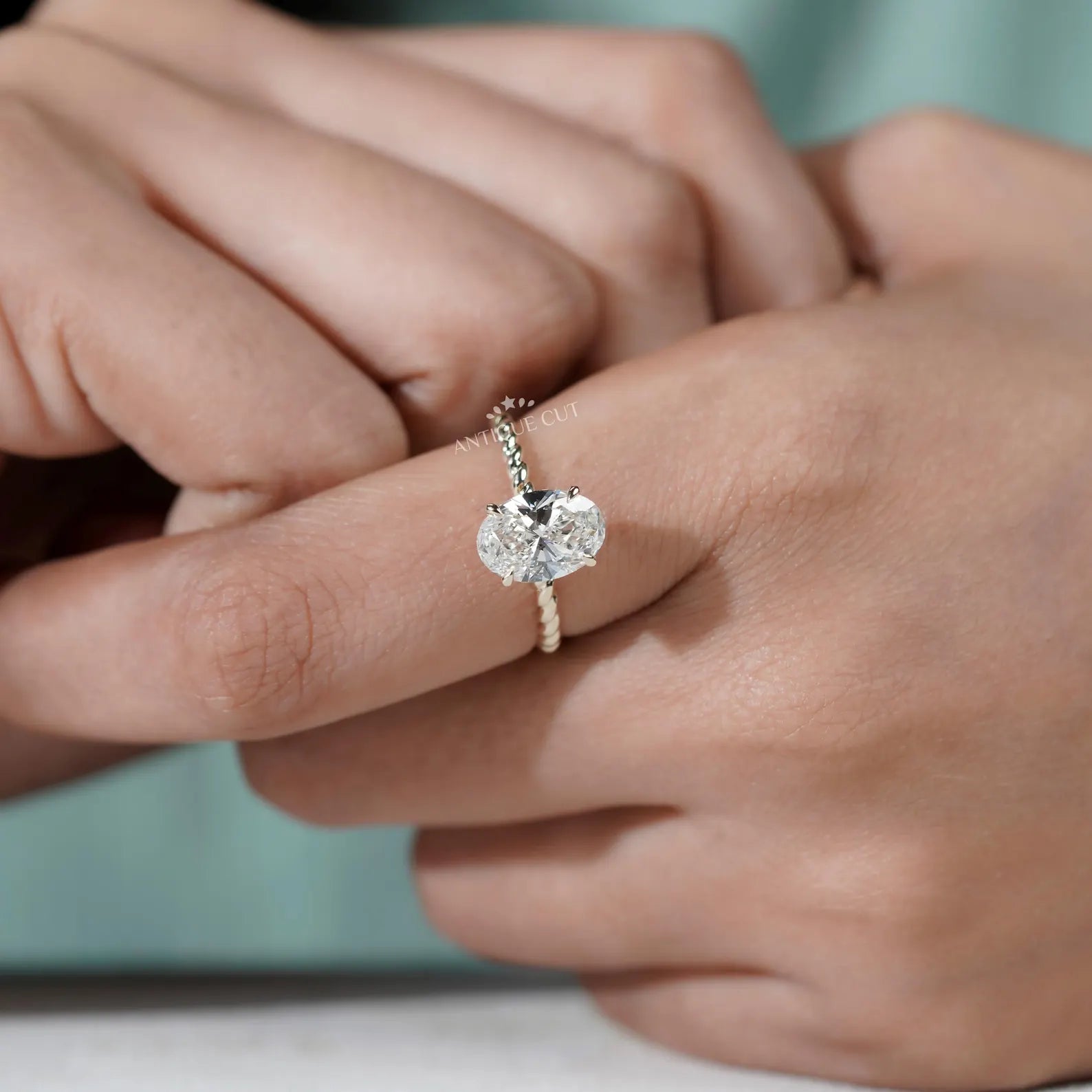 Hidden Halo Oval Cut Engagement Ring with Twisted Gold Band