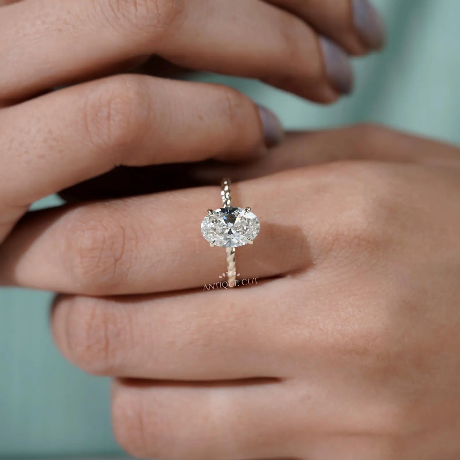 Hidden Halo Oval Cut Engagement Ring with Twisted Gold Band