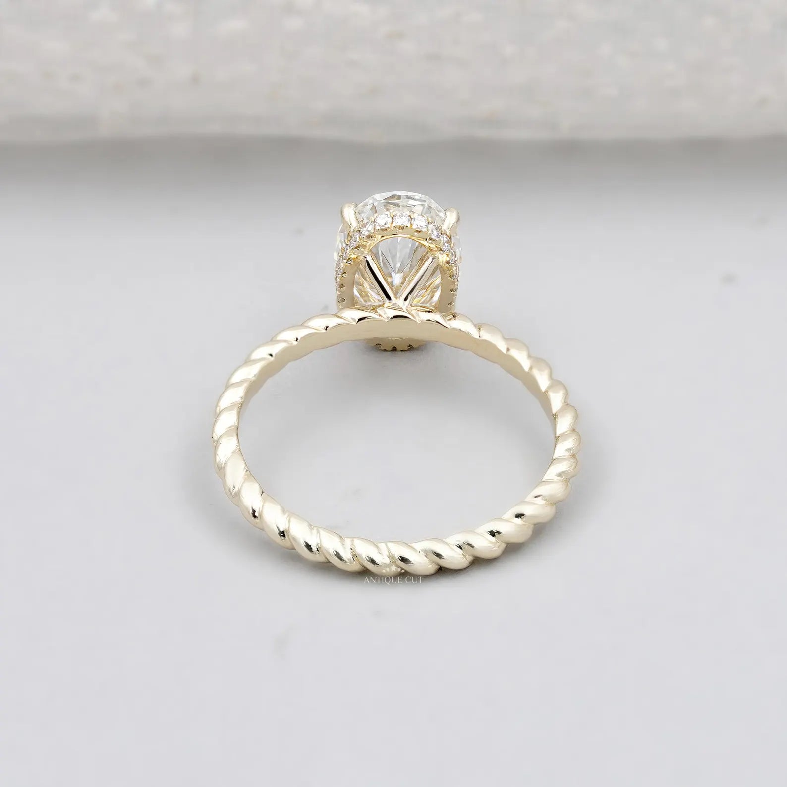 Hidden Halo Oval Cut Engagement Ring with Twisted Gold Band
