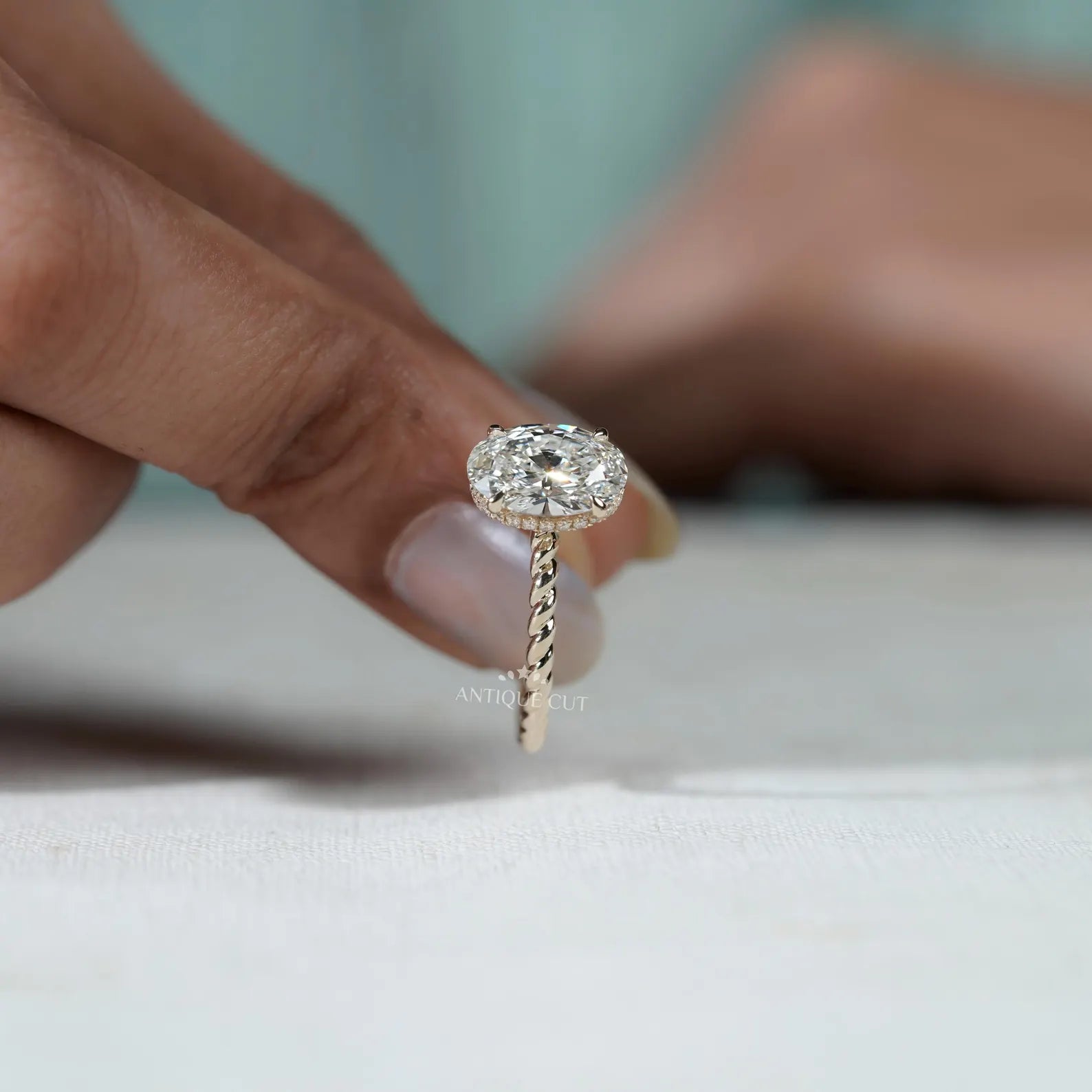 Hidden Halo Oval Cut Engagement Ring with Twisted Gold Band