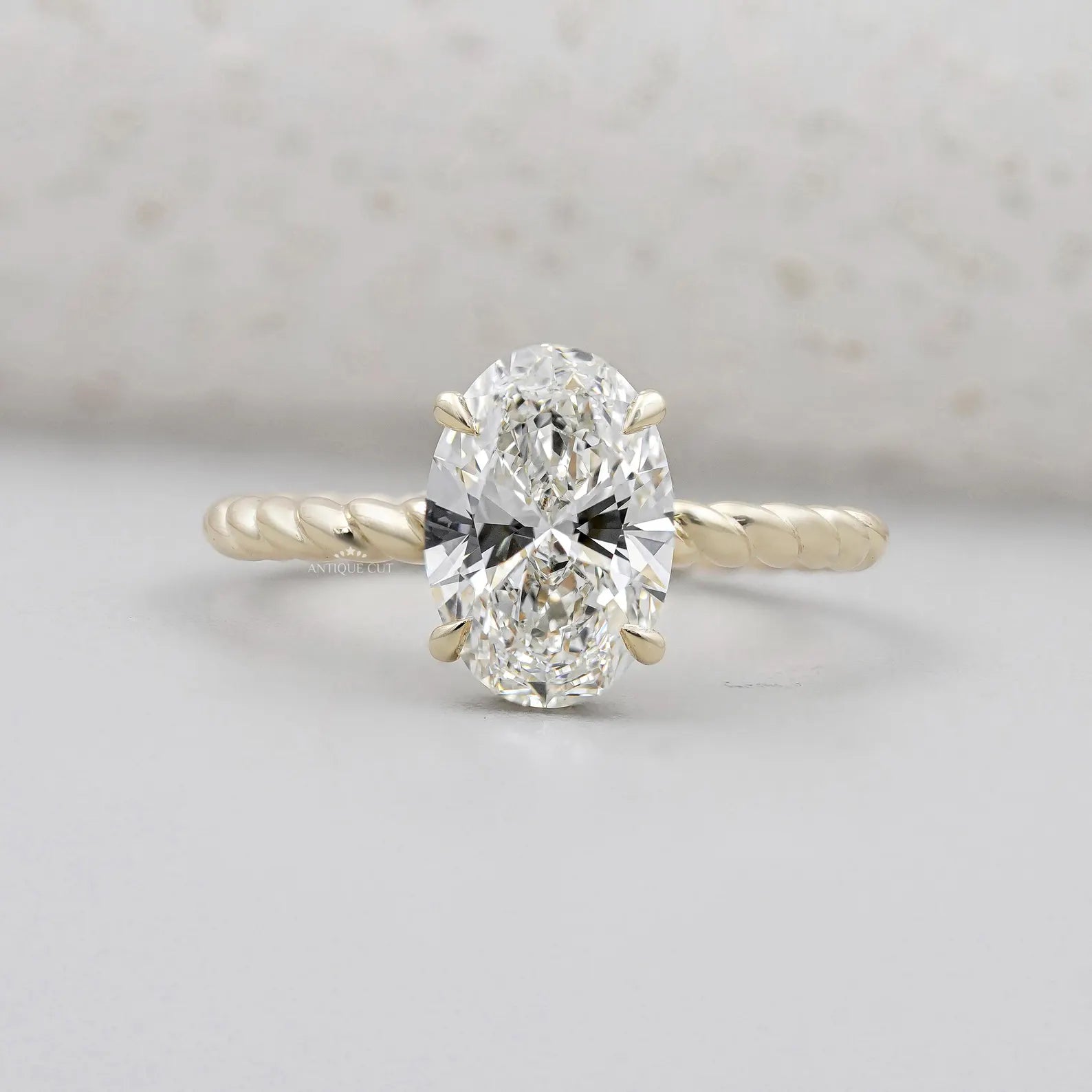 Hidden Halo Oval Cut Engagement Ring | Twisted Gold Band in Yellow Gold | IGI Certified
