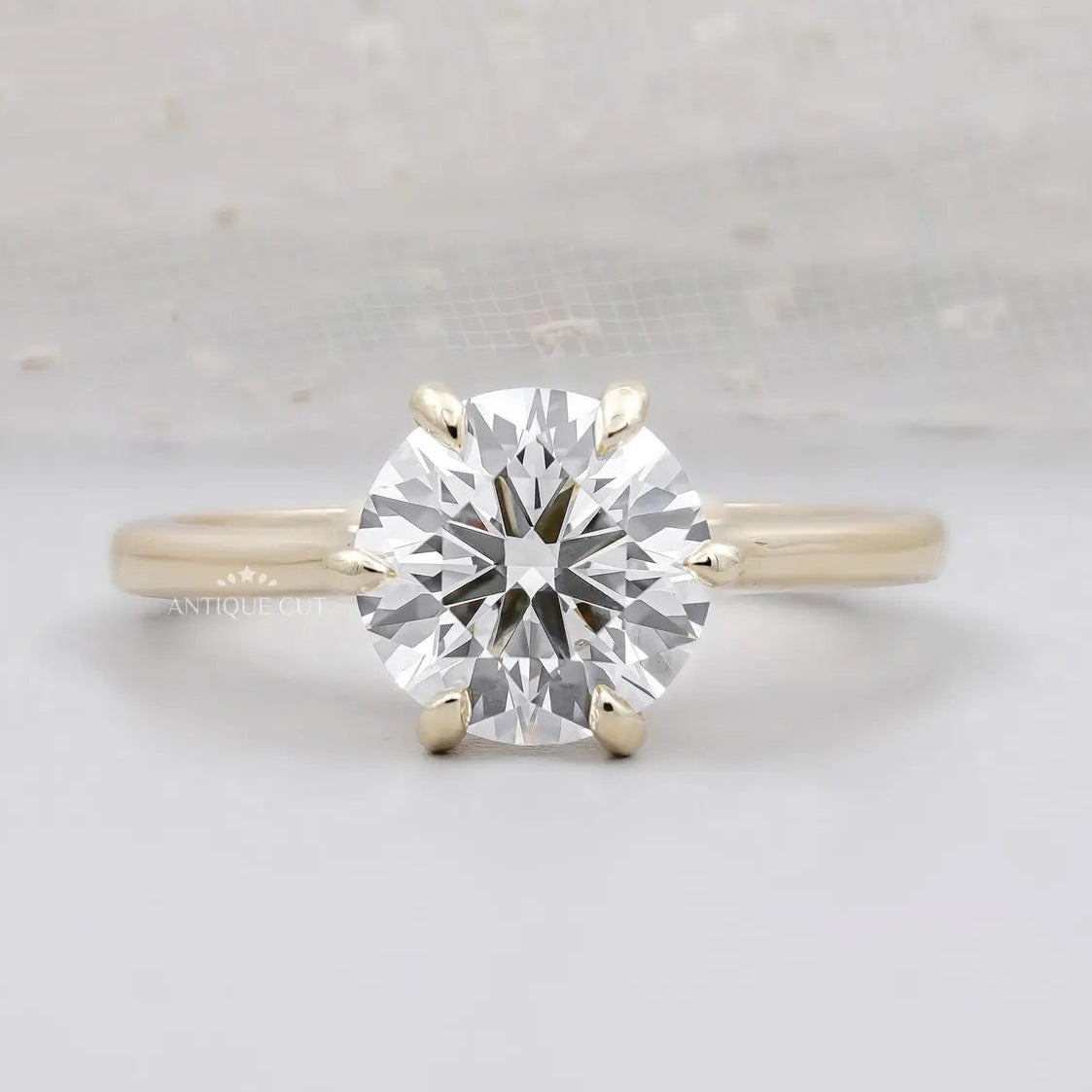 Round cut engagement ring with six prong solitaire setting