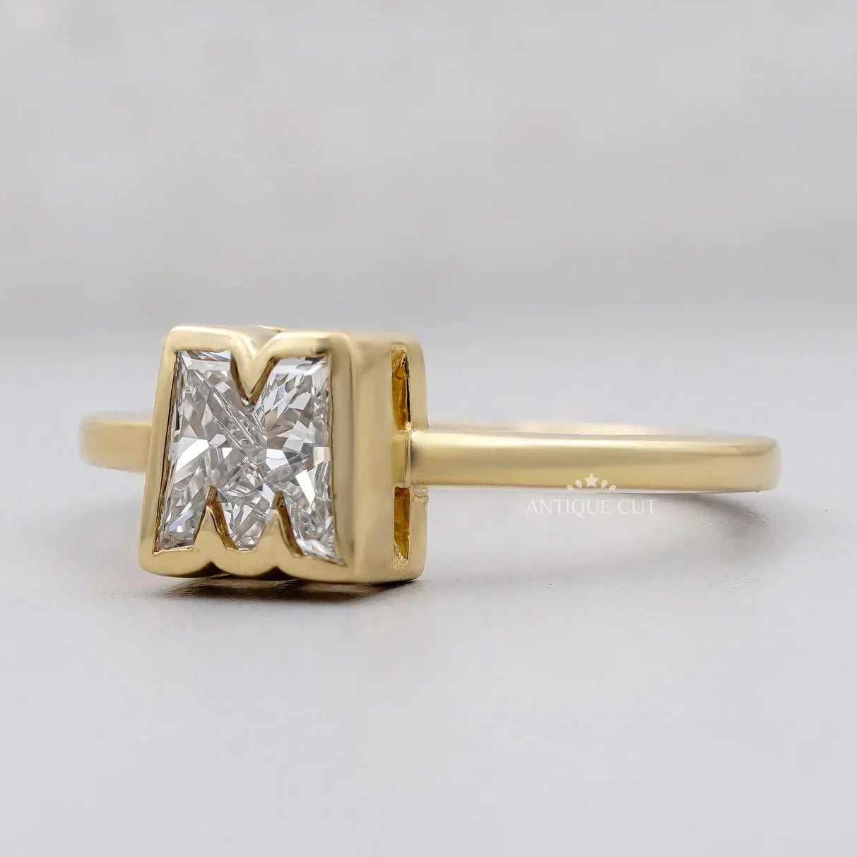 Lab grown diamond M initial ring in polished yellow gold