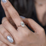 Oval diamond cathedral engagement ring with pavé band
