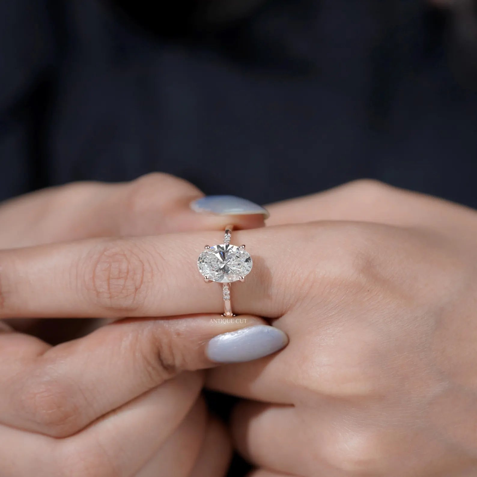 Pavé oval diamond engagement ring in rose gold