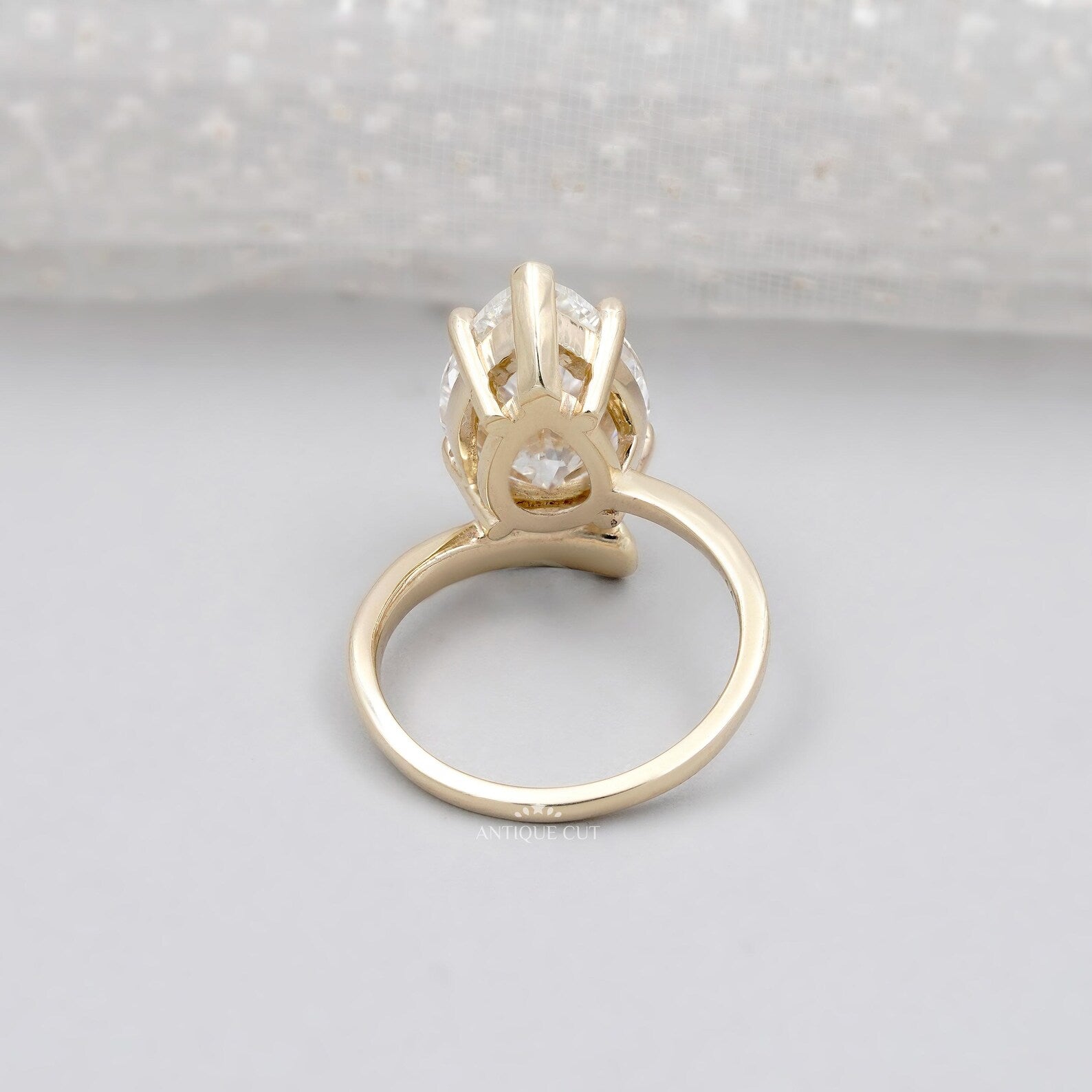 Pear shaped lab grown diamond ring with V prong and yellow gold band