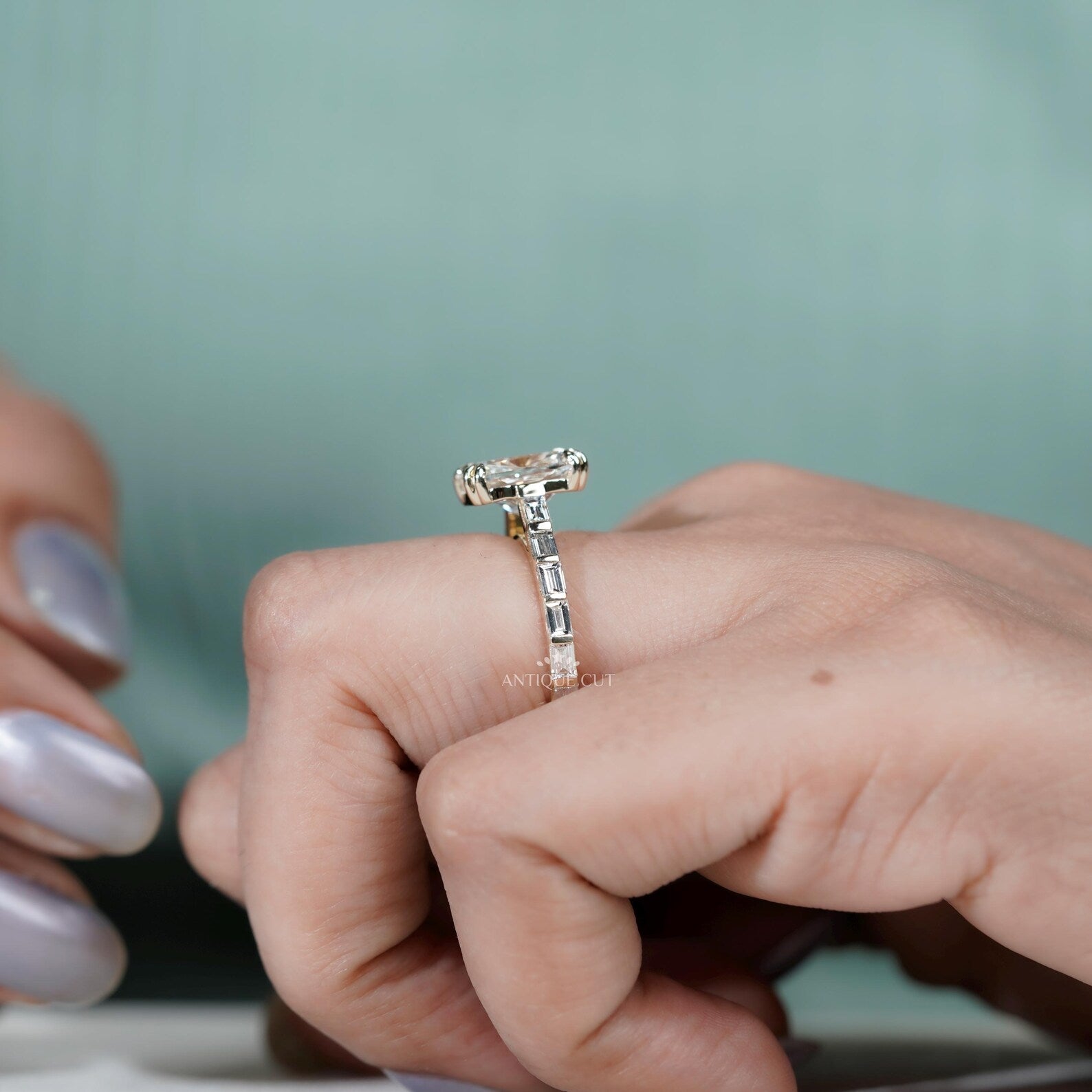 Cushion diamond engagement ring with double claw prongs and yellow gold pavé band