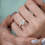 Cushion cut yellow gold engagement ring with double claw prongs and diamond pavé band