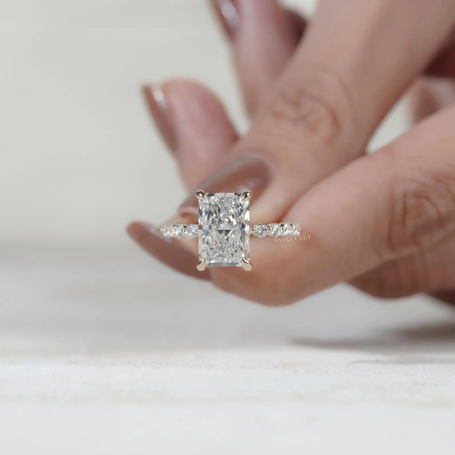 Radiant diamond engagement ring with yellow gold band and secure claw prong setting