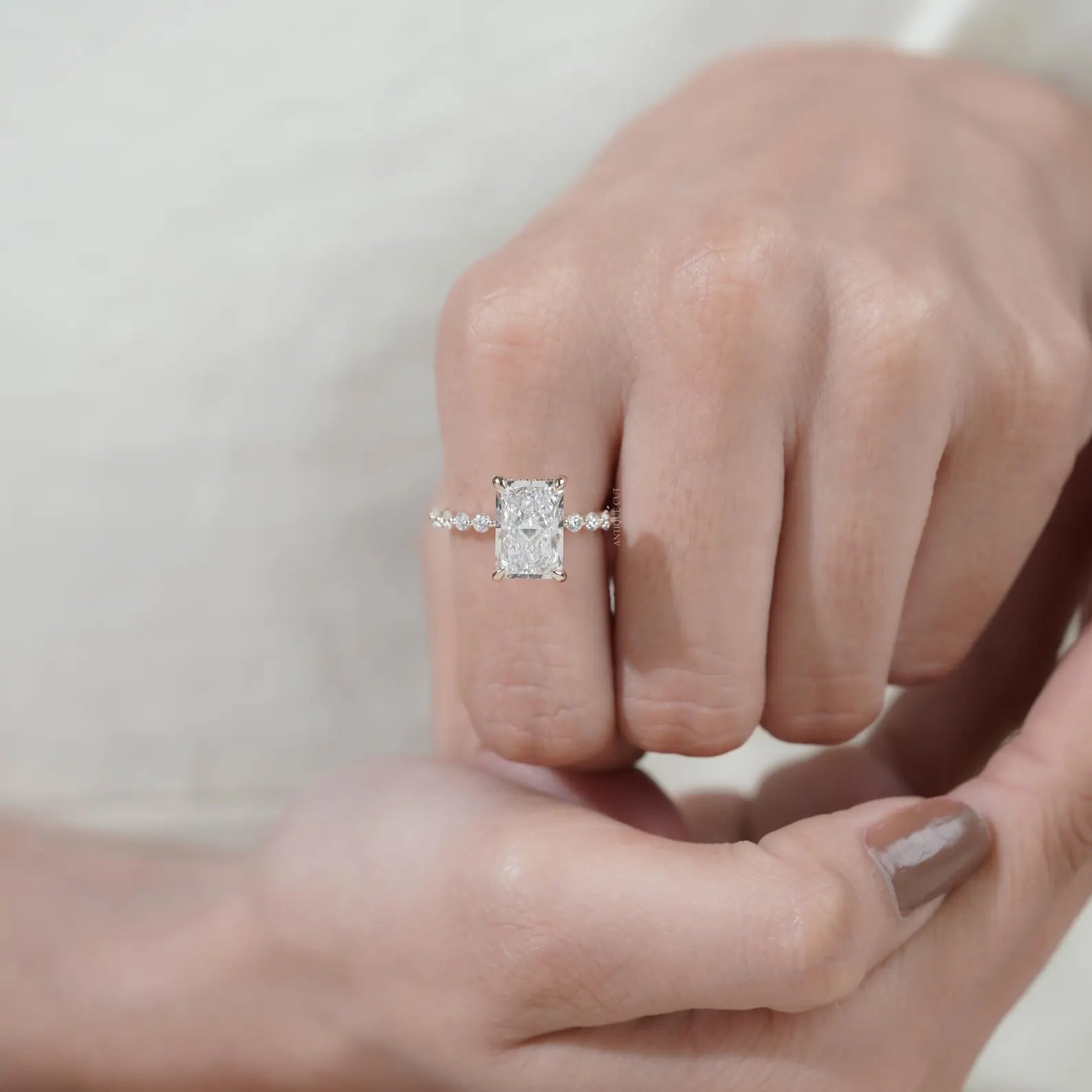 Radiant cut lab grown diamond ring with claw prongs and pavé accented yellow gold band